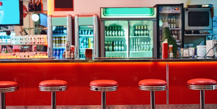 Retro, vintage and stools with interior in a diner, restaurant or cafeteria with funky decor.