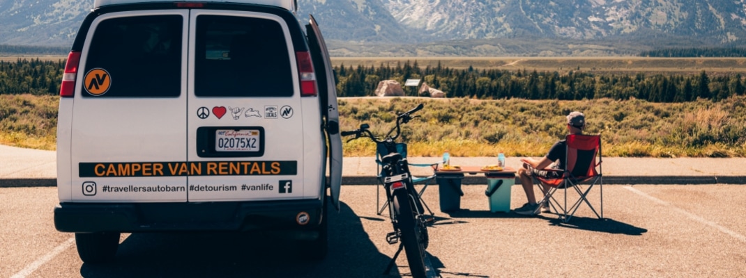 Person with bike and campervan at Grand Teton National Park