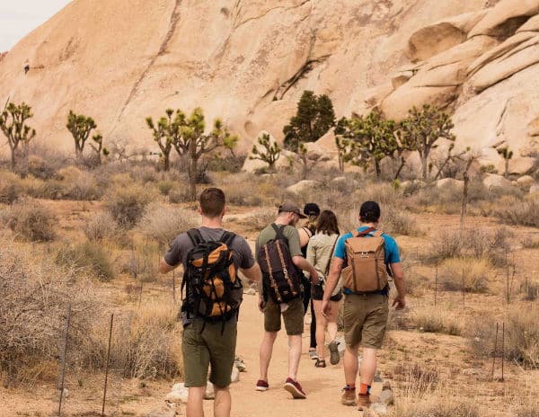 group of people hiking in Joshua Tree