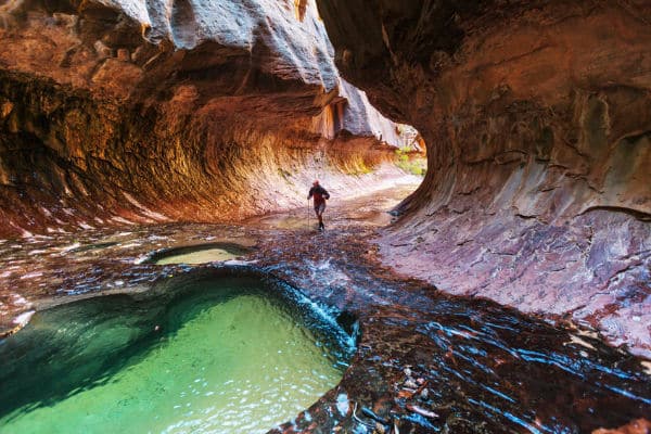 Woman walking the Narrows in Zion