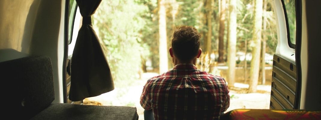 View out the back of a campervan in forest in the USA