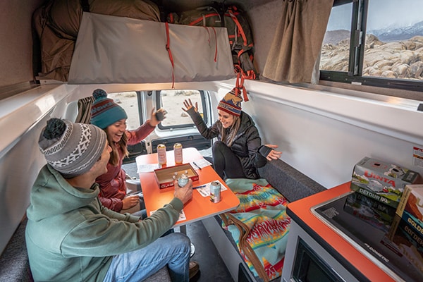 Friends inside a campervan