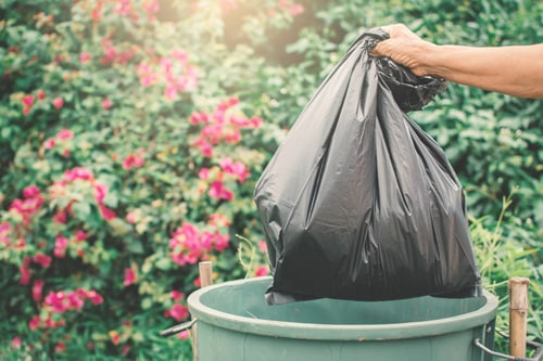 garbage bags being placed in the bin