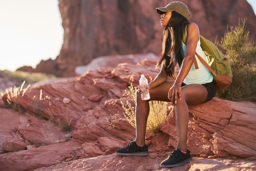 woman hiking with water bottle