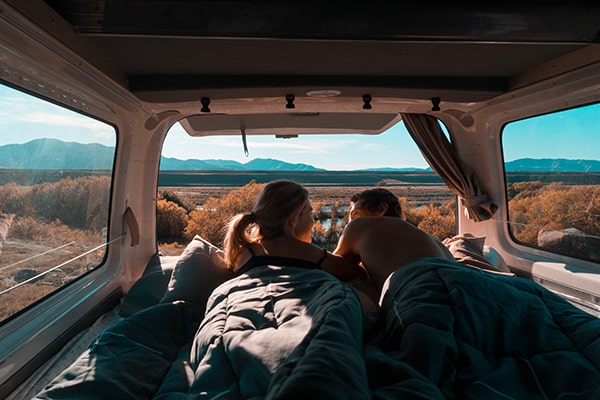 Couple in the back of a campervan