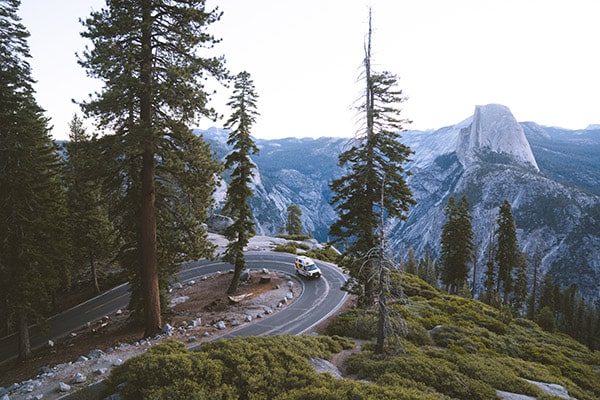Campervan driving along a road in Yosemite National Park