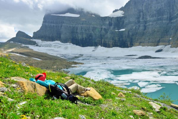 Hiker resting at Grinnell Glacier in GNP