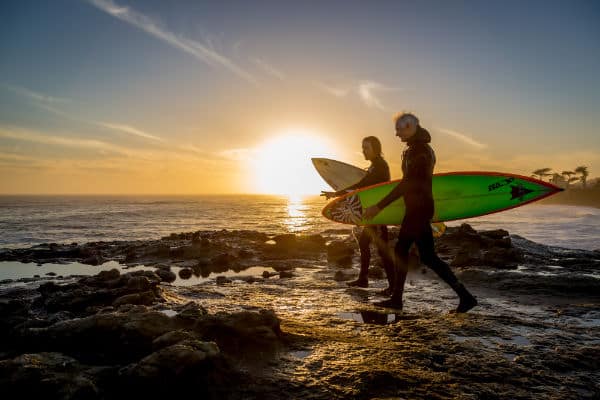 two surfers heading out in Santa Cruz