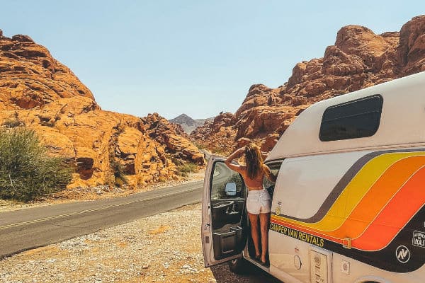 female standing in campervan looking towards Valley of Fire