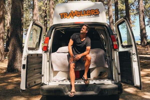 male sitting in campervan at Tahoe