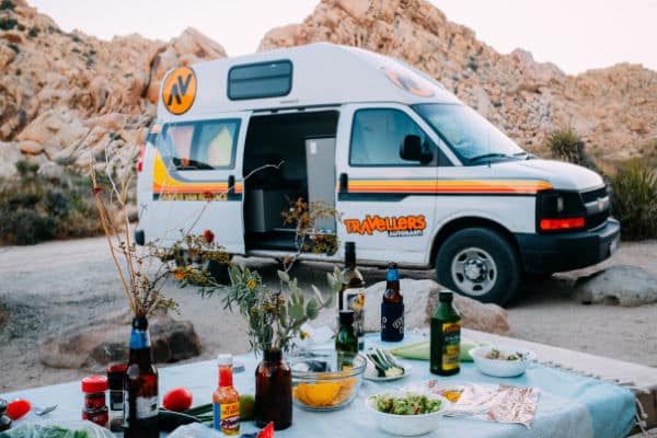 Campervan and picnic table with food