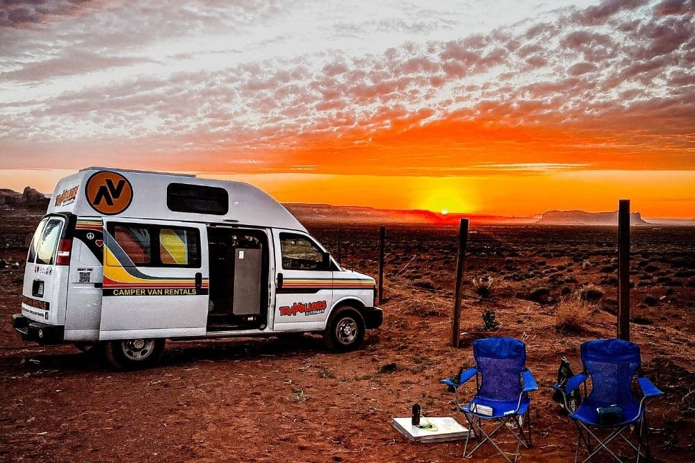 Campervan, camp chairs and sun rise