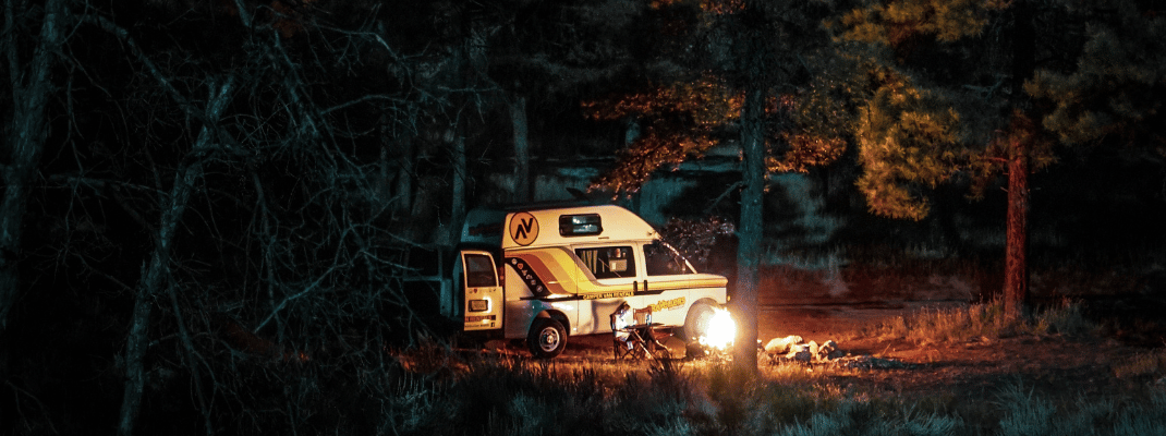 Campervan in forest with campfire 