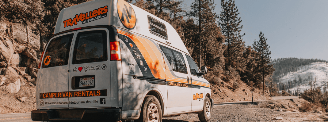 Campervan next to road in mountains