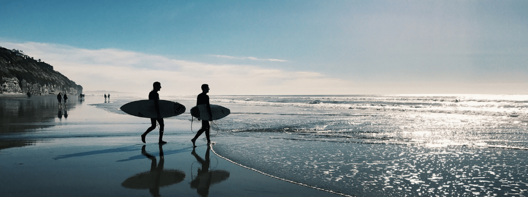 Two surfers on the beach in San Diego