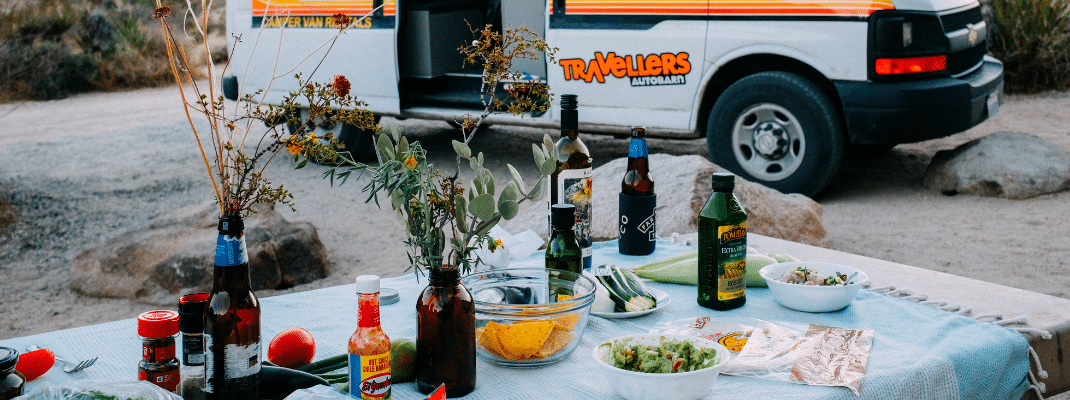 Table setup for a meal next to a campervan, USA