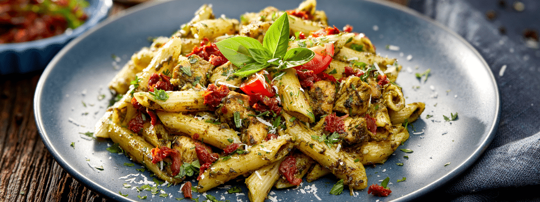 Penne pasta with pesto and tomatoes