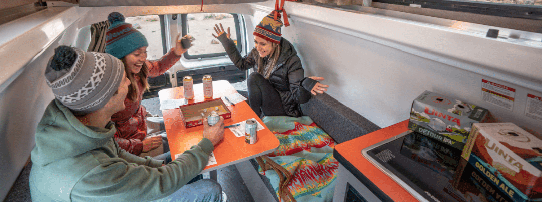 People playing board game in back of campervan, USA