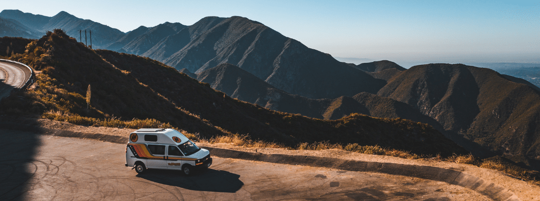 Campervan in car park overlooking mountains in the USA