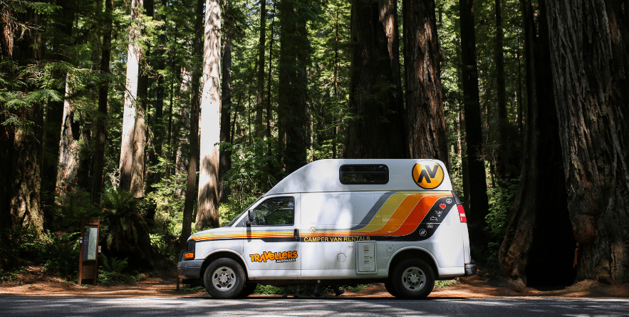 Campervan driving through Redwood Forest, USA