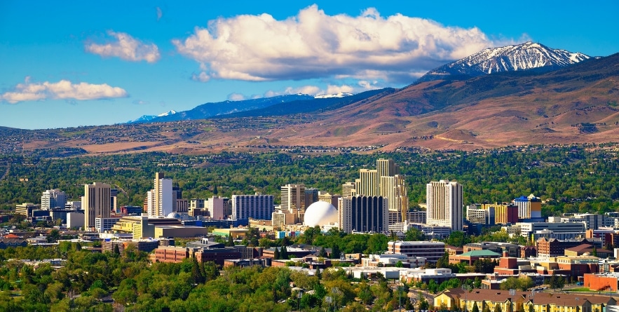 Downtown Reno skyline, Nevada, with hotels, casinos and the surrounding High Eastern Sierra foothills