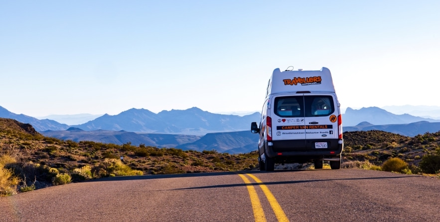 Campervan driving on road through Death Valley, USA