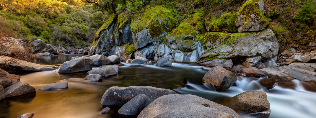 fall colored foliage among the smooth flowing water of the Mokelumne River