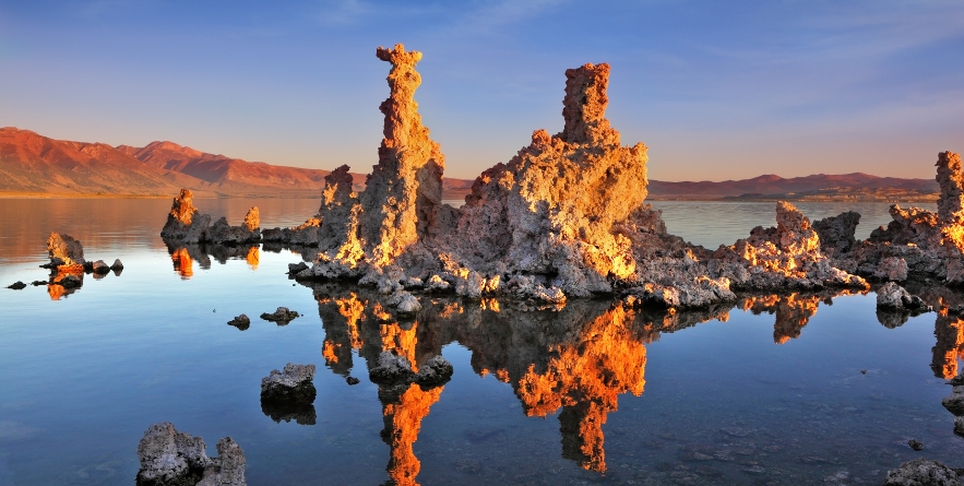 The magic of Mono Lake. Outliers - bizarre calcareous tufa formation on the smooth water of the lake