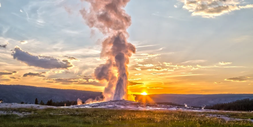 Old Faithful Geyser Eruption in Yellowstone National Park at Sunset